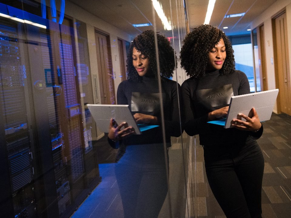 Two engineers with tablets in a server aisle